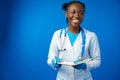 Black female doctor student wearing a lab coat with book Royalty Free Stock Photo