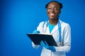 Black female doctor student wearing a lab coat with book Royalty Free Stock Photo