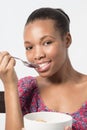 Black Female eating her Breakfast with spoon Royalty Free Stock Photo