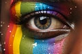 Black female eye closeup. Eye painted in rainbow LGBT colours