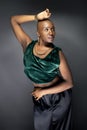 Black Female Fashion Model with Bald Hairstyle and Green Clothing Royalty Free Stock Photo