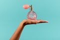 Black female hand showing classic perfume bottle Royalty Free Stock Photo