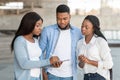 Black female interviewer conducting survey with young african american couple outdoors Royalty Free Stock Photo