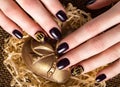 Black female manicure nails closeup with crown