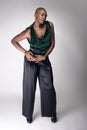 Black Female Model With Bald Hairstyle and Green Clothing Royalty Free Stock Photo