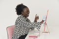 Black female office worker cleaning computer screen. Smiling woman. Royalty Free Stock Photo