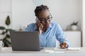 Black Female Office Worker Talking On Cellphone With Client And Taking Notes Royalty Free Stock Photo