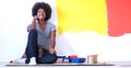 Black female painter sitting on floor