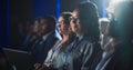 Black Female Sitting in Dark Crowded Auditorium at an International Business Conference. Multiethnic Royalty Free Stock Photo