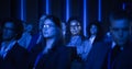 Black Female Sitting in a Dark Crowded Auditorium at an International Business Summit. Multiethnic Royalty Free Stock Photo