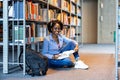 Black female student reading a book in a library Royalty Free Stock Photo