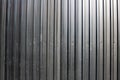 Black fence made of corrugated board, background Royalty Free Stock Photo