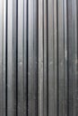 Black fence made of corrugated board, background Royalty Free Stock Photo