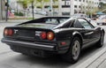 Black Ferrari 308 GTSI parked in an urban setting, reflecting city surroundings Royalty Free Stock Photo