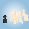 A black figure stands apart from a group of identical shapes. The concept of the meeting, recitation, distinctive features