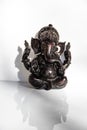 Black figurine of Lord Ganesh with white background