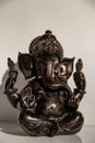 Black figurine of Lord Ganesh with white background