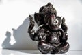 Black figurine of Lord Ganesh with white background