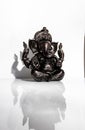 Black figurine of Lord Ganesh with white background