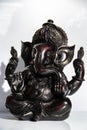 Black figurine of Lord Ganesh with white background