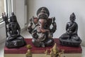 Black figurines of Shiva, Ganesha Buddha on the windowsill Royalty Free Stock Photo