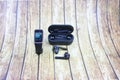 Black fitness watch (activity tracker) and True Wireless Stereo (TWS) . Closeup, selective focus