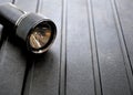 Black flashlight on rugged background. Royalty Free Stock Photo