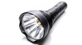 A black flashlight with a white light Royalty Free Stock Photo