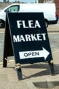 Black Flea Market sign stating that it is open and pointing the direction Royalty Free Stock Photo