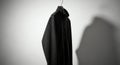 Black Fleece Jacket Hanging on Hook, Shadow, Minimalist Style Royalty Free Stock Photo