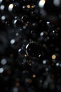 Black Floating Bubbles, Close-up image of black bubbles floating in a dark setting, creating a visually intriguing and