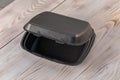 Black foam and plastic food container on wood table background Royalty Free Stock Photo