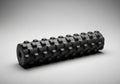 Black foam roller with a textured, grid-like surface designed for Royalty Free Stock Photo