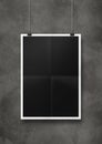 Black folded poster hanging on a concrete wall with clips Royalty Free Stock Photo