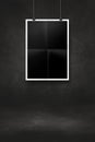 Black folded poster hanging on a black wall with clips Royalty Free Stock Photo