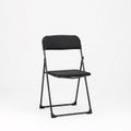 A black folding chair, isolated on a white Royalty Free Stock Photo