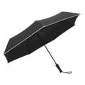 Black folding umbrella with white trim and black handle on white background image Royalty Free Stock Photo