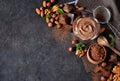 Black food background with cocoa, nuts and chocolate