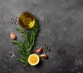 Black food background with olive oil, rosemary, lemon and spices. Royalty Free Stock Photo