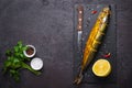 Black food background with Smoked mackerel fish and spices Royalty Free Stock Photo