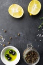 Black food frame background with fresh aromatic herbs and spices, copy space, top view. Allspice, thyme, lemon, olives Royalty Free Stock Photo