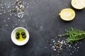 Black food frame background with fresh aromatic herbs and spices, copy space, top view. Allspice, thyme, lemon, olives Royalty Free Stock Photo