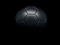 Black football or soccer ball against black background