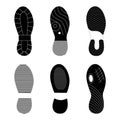 Black footprint shoes and sneakers collection.Various isolated silhouettes of an imprint soles shoes. Vector set of Royalty Free Stock Photo