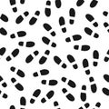 Black footprints seamless pattern white background. Footsteps silhouette