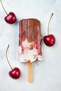 Black Forest chocolate fudge popsicles with roasted cherries and coconut cream. Vegan creamy ice pops, nicecream, fudgesicles. Royalty Free Stock Photo