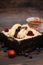 Black forest gateau cake with fruits and cup of tea