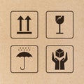 Black fragile sign and symbol on brown cardboard paper.