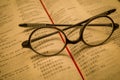 Black frame glasses are placed on the Chinese-English Bible Royalty Free Stock Photo