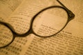 Black frame glasses are placed on the Chinese-English Bible Royalty Free Stock Photo